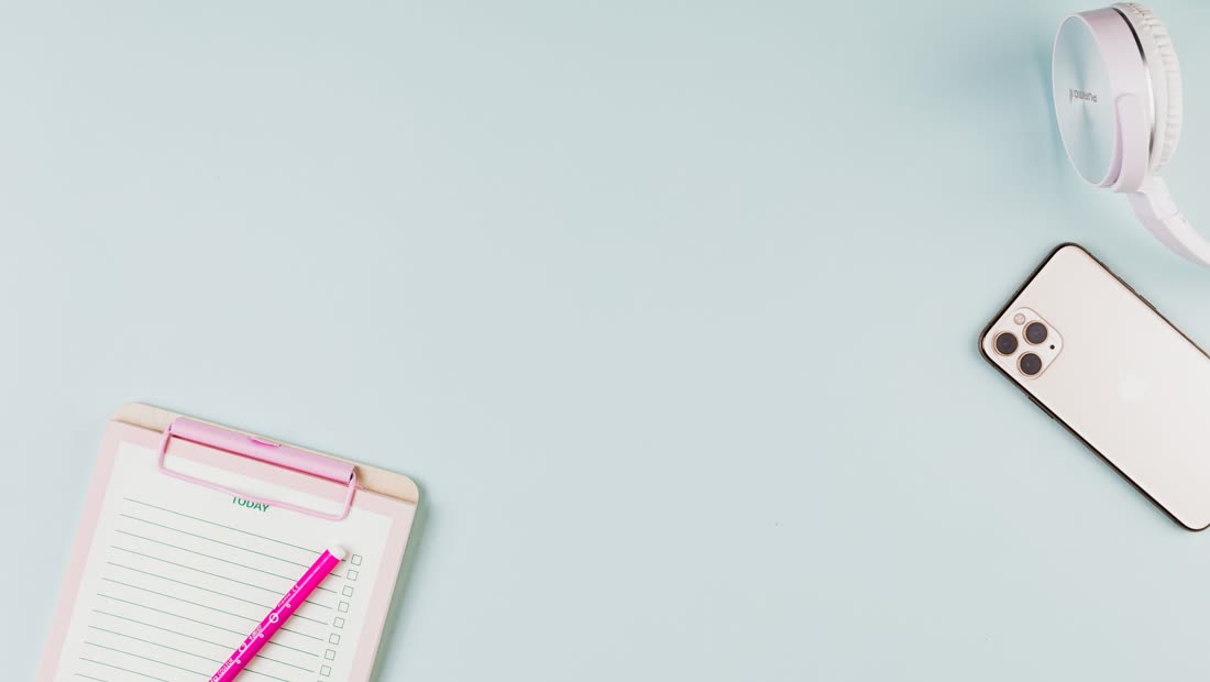 A checklist next to a phone for comparing tracker features