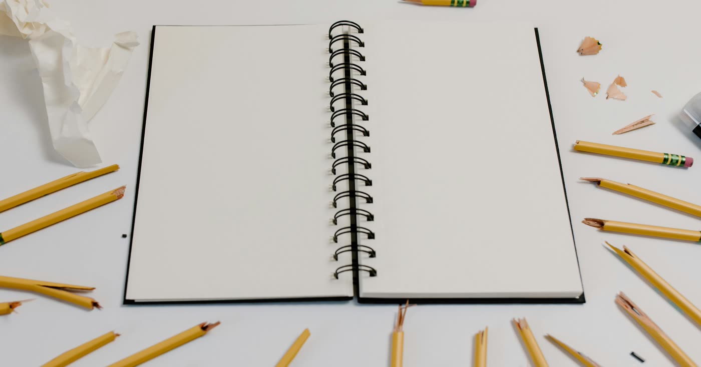 A broken pencil and notebook for trying again after failing before