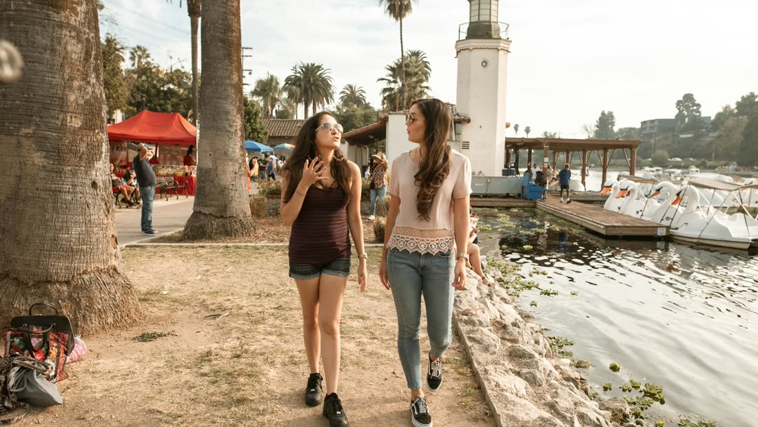 Two friends walking by a lake instead of taking a smoking break