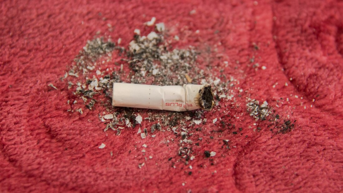A single cigarette on red fabric, representing the just-one-cigarette bargain